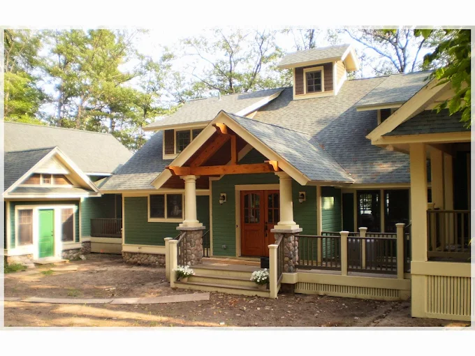 Harbor Construction custom home exterior in Maple City, Michigan featuring stone work and carpentry